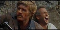 Butch (Paul Newman) knekker sammen i latter når Sundance Kid (Robert Redford) avslører at han ikke kan svømme.